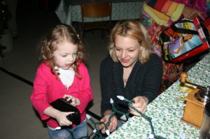 Michelle Marino Drake of Bolton was helping her daughter Madeline Drake, 4, turn the crank to get the lights on the table to work. 