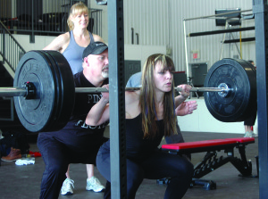 The Highland Powerlifting Club held a test day March 23, and invited members of the public to come out and see what the sport is all about. New member Lisa Coyne shows good form while doing a squat with a heavy set of weights. 