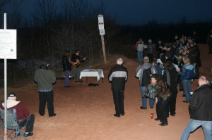 CROWD OUT TO WELCOME EASTER AT BADLANDS Rev. Harvey Self of Tweedsmuir Presbyterian Church in Orangeville was assisted by Emma Duncan Sunday in conducting this well-attended Easter Sunrise service at the Cheltenham Badlands on Olde Base Line Road. Those attending the service, which started at 6:45 a.m., were there before the sun. Photo by Bill Rea 