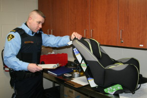 MAKING SURE THE SEAT CHECKS OUT Caledon OPP and their auxiliarys officers hosted the latest in their series of child car seat clinics recently. Auxiliary Constable Shane Atkinson was checking this seat to make sure it met with all the specifications. The next such clinic will be April 30, from 6:30 to 8:30 p.m. at the detachment station at 15924 Innis Lake Rd., by appointment only. For more information or to book an appointment, call 905-857-3304 and ask for Rosalyn. Photo By Bill Rea