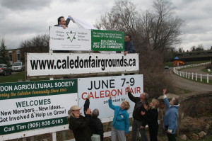 Caledon Agricultural Society Vice President Tim Forster and President Stan Dacres unveiled the banner Friday to celebrate the grant of $62,600 from the Ontario Trillium Foundation, to the delight of Society Creative Director Barb Shaughnessy, Councillor Doug Beffort, Sheila Tutty of the Trillium Foundation, Society Secretary Clarence Pinkney, Dufferin-Caledon MPP Sylvia Jones and Society Treasurer Marion Standish. Photo by Bill Rea 