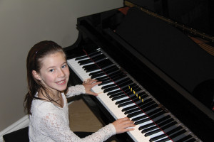 Devon Plaskett tries out her Yamaha GB1K grand piano.