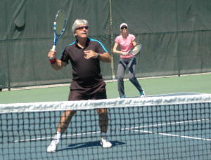 Tennis players Robert Maciag and Natalie Murray wait for the return during a game on the courts at the Bolton Tennis Club. The club had its opening day for the season Saturday. Photo by Brian Lockhart