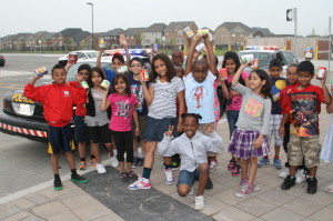 LOTS OF CONTRIBUTIONS FOR FOOD BANK Staff and students at Southfields Village Public School have been busy collecting food contributions for their Cram the Cruiser event. Caledon OPP was on hand yesterday (Wednesday) to provide the cruisers for the young folks to cram, including this happy group of Grade 2 students. The collected food will be going to a local food bank. Photo by Bill Rea 