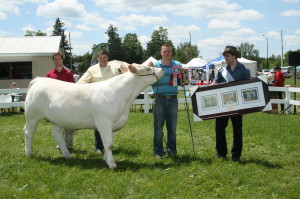 The weather started off looking a little ominous, but things improved over the weekend to help make Caledon Fair a success. Being an agricultural fair, there were many animals being shown, and Kyle Stevenson from Action had the best one in Cedardale Miss Zaida, a pure bred Charolais yearling. They are seen here with the judge Nathan Stirk, fair volunteer Matthew Stevens and Fair Ambassador Patrick Forster.