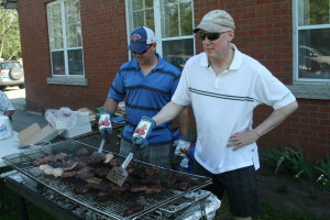 STEAK BARBECUE AT CHURCH Caledon East United Church hosted its annual Steak Barbecue recently, and they had a good crowd out for the event. There were plenty of steaks on the grill, and Sean Davis and Dave Dexter were busy working on them. Photo by Bill Rea