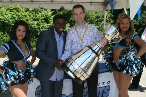 Toronto Argonauts' Vice-Chair Mike “Pinball” Clemons and Husky's Vice President of Corporate Services and General Counsel Michael McKendry had a good grip on the Grey Cup, accompanied by Argo cheerleaders Natalie and Rachel.