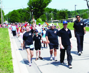POLICE TAKE PART IN SPECIAL OLYMPICS TORCH RUN Caledon OPP Constables Alicia McCracken and Nav Kaila were joined by athletes Robert Hawley, Jerry Dasilva and Liam Edwards as they led students from St. Cornelius Elementary School on a torch run through Caledon East recently. The fundraising event was in support of the Summer 2013 Special Olympics being held in York Region (Newmarket) from July 11 to 14. Photo by Bill Rea