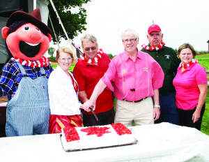 The festivities at Downey's included the cutting of this ceremonial cake. Doing the honours were mascot Dudley Downey, Dufferin-Caledon MPP Sylvia Jones, Councillor Gord McClure, Dufferin-Caledon MP David Tilson, and John and Ruth Downey.