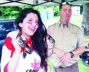 There were celebrations throughout Caledon Monday in honour of Canada Day, including the annual festivities at Albion Hills Conservation Area. Caledon East area resident Sarah Power was all decked out in the colours of the flag to meet Monty, a bald python that was brought by Blair Watson of Reptilia.