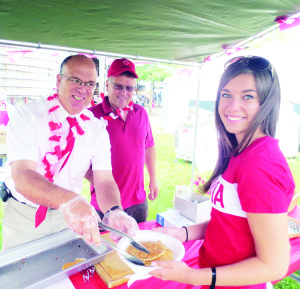 Downey's Farm hosted their annual Strawberry Festival Monday. The festivities started with a pancake breakfast. Councillors Allan Thompson and Gord McClure were serving Belfountain resident Alaina Wallace.