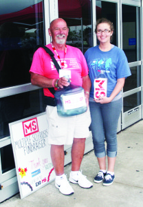 $7,000 RAISED TO FIGHT MS Cedar Mills resident Julie Dranitsaris was joined by Bill Bates recently outside the Walmart store in Bolton. She spent the weekend continuing her efforts to raise money to fight Multiple Sclerosis. Her father Steve reported the effort resulted in a contribution of $7,007.98 to the cause, and that includes a matching grant from Walmart. Photo by Bill Rea