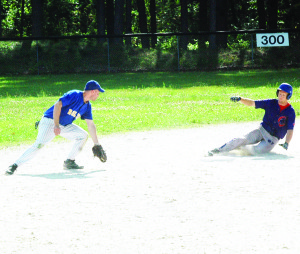 A Mansfield Cubs base runner makes to first on a dropped ball during the first game of their double header against the Bolton Brewers. Photo by Brian Lockhart
