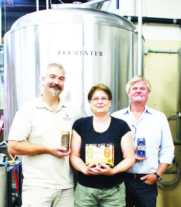 Founder and president Tom Smellie (right) with brewmaster Andrew Kohnen and Operations Manager (aka Den Mother) Deborah Whiteley show where the magic happens at the Hockley Valley Brewing Co. in Orangeville by showing off some of their new products Photo by Lindsey Papp