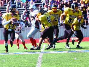 TNT quarterback Andrew Tee looks for a receiver during  the Ontario Minor Football League championship game held Sunday at Esther Shiner Stadium. The Express claimed the Varsity championship with  a 28-7 win over Orangeville. Photo by Brian Lockhart 