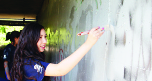 Graffiti is always a problem under bridges, and camp participants were working on it. Amber Timm was applying some paint under the bridge at Queen and Hickman Streets in Bolton.