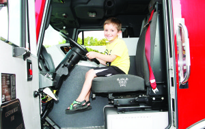 Personnel from the local fire hall were taking part in the Madness, letting the young folks like Marcus Rodrigues, 5, of Bolton check out their equipment.