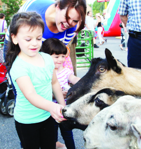 The annual Midnight Madness hit the Bolton valley again Friday night, and there was a large and enthused crowd out to enjoy the fun. The attractions included this petting zoo, and Christina Oppedisano of Bolton was helping her daughters Julia, 4, and Sofia, 2, feed the animals.