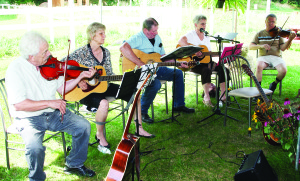 GARDEN PARTY AT PEACE RANCH There was a peaceful atmosphere around Peace Ranch recently as the community-based agency offering full-time supportive housing and rehabilitation programs for people living with mental illness hosted a garden party. The activities included music provided by these members of the Bondhead Fiddle Club. Seen here performing are Rudy Denova, Diane Stewart, Rod McMillan, Ginny Pletts and Ed Elliotson. Photo by Bill Rea