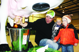 The were plenty of hand-on experiences at the Fair. They included this model for people to practise their milking skills. Phil Lankhof of Orangeville was showing his sons Avery and Nolan how it's done.