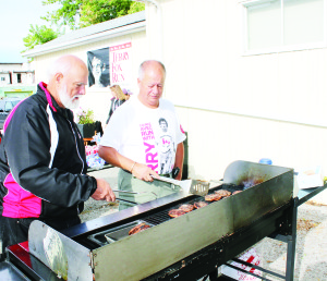 Bob Smith and Steve Vickers were handling some of the cooking chores for the Kinsmen.
