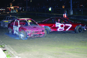 The Fairgrounds were a busy place Friday night, as the rain held off long enough to get a good crowd in the stands for the annual demolition derby. There was lots of speed and smashing of cars to keep the audience entertained. Photos by Bill Rea