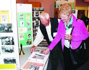 REUNION TIME IN CALEDON EAST There was lots of nostalgia Saturday at St. James' Church in Caledon East. The occasion was a school reunion, as staff and students of the old Caledon East School got together. Bill Robbins and his sister Pat Caruso were going through some of the memorabilia. They attended the school in the 1940s. Photo by Bill Rea
