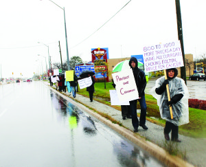 STILL PROTESTING CANADIAN TIRE DEVELOPMENT It was a lousy day for marching, but a couple of dozen people braved Saturday's rain to take part in this march along Queen Street South in Bolton, protesting the planned massive distribution centre planned by Canadian Tire in the industrial area. Local resident Kim Seipt, who's been helping to lead the fight, said it was another opportunity for people who might not have been able to get to the previous march last month to get out and show their support for the effort. Photo by Bill Rea