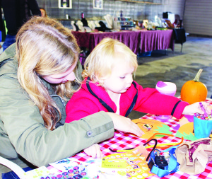 Farmer's Market done for the year Thanksgiving weekend marked the last day of the Caledon Farmer's Market at the Bolton Fairgrounds for the year. The several booths were in full operation, and there were other activities taking place. There were crafts for the younger folks. Emma Van Buskirk of Bolton was assisting her 23-month-old daughter Charlotte Dolman with her creation