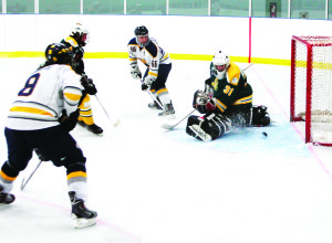 Caledon Golden Hawks forwards Christian Bonaldi and Daniel Cafagna team up to score the tying goal in Sunday night's game against the Stayner Siskins, while Siskins' goalie Taylor Trace watches the puck cross the goal line. The Hawks lost 4-3 after the game went into a shoot-out to determine the winner. Photo by Brian Lockhart