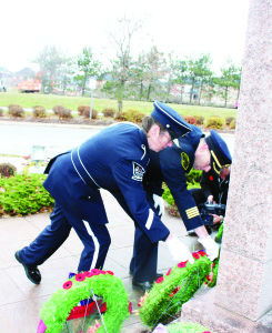 Firefighter Kaaren Densham and Deputy Chief of Operations for Caledon Fire and Emergency Services Darryl Bailey were taking their turn depositing their poppies on wreaths at the Cenotaph at Town Hall after Monday's Remembrance Day services.