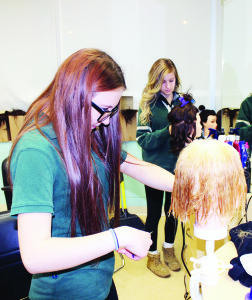 Heidi Scheer-Henning and Skylar Micallef were showing some of the activities taught in the cosmetology classes.