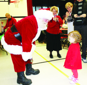 Santa welcomed at school There was a large and hungry crowd out at Herb Campbell Public School last Saturday morning for the annual Breakfast with Santa. Rosie Niewojt, who's mother Jennifer teaches at the school, was perfectly positioned to greet the guest of honour on his arrival. Samantha Miller, a senior kindergarten student, got to sit on Santa's lap. Photos by Bill Rea