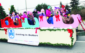 It just looked like a sleigh, but these 1st Bolton Girl Guides had a good time waving at the crowds along the parade route.