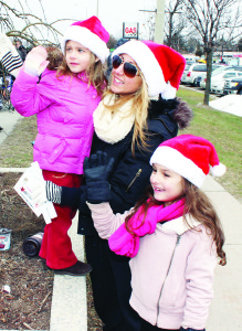 Gianna Moscarella of Nobleton made sure her daughters Olivia, 4, and Leah, 7, were in good position to greet Santa.