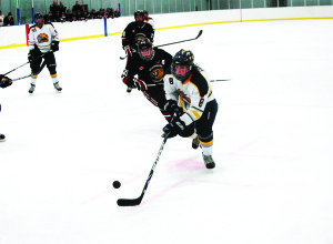Caledon Golden Hawks' forward Christian Bonaldi dekes around a Schomberg defender during the second period of Sunday's Junior C game at Caledon East. The Hawks dropped a two-goal lead to lose 4-3 in overtime, but split the weekend with a Friday night win in Midland. Photo by Brian Lockhart
