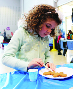 Leyla Garcia, 6, of Bolton was woking on her cookie-decorating skills in Bolton Sunday.