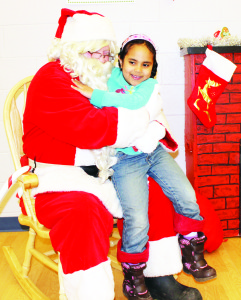 The Town hosted Holiday Fest events over the weekend, attracting plenty of people to Bolton and Caledon East for afternoons of holiday fun. Santa Claus was on hand at the Caledon Centre for Recreation and Wellness in Bolton, meeting many of his friends, including Maryam Schumann, 4, of Bolton. Photo by Bill Rea