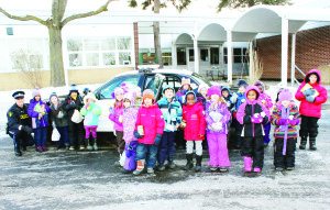 Caledon OPP Constable Clyde Vivian was on hand to meet students from Herb Campbell Public School as they did their bit in cramming cruisers in support of the efforts for the Orangeville Food Bank. Photo by Bill Rea