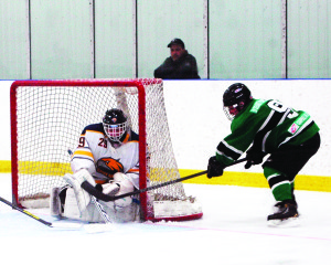 Caledon Golden Hawk goalie Chris Vellucci stops a wrap-around shot by  Erin Shamrocks' Josh Sguigna during the third period of Sunday's game in Caledon East. The Hawks gave up two third-period goals that cost them the game as they lost 5-4. Photo by Brian Lockhart