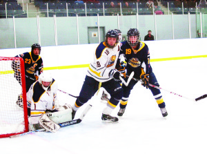 Caledon Golden Hawk defenceman Zack Worth held back a player in front of the Caledon net during the second period of Sunday's game against the Huntsville Otters. The Golden Hawks collected their second win of the weekend, leaving the ice after dispatching the visitors 7-3. Photo by Brian Lockhart