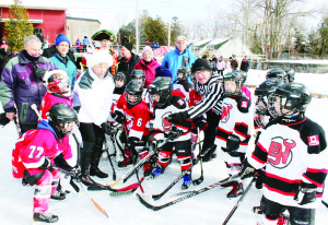 LOTS OUT FOR MILLPOND CLASSIC There were freezing temperatures Saturday, but that's what's needed for pond hockey. So the conditions were perfect for the fifth annual Alton Millpond Hockey Classic. Mayor Marolyn Morrison and famed NHL Lineman Ray Scapinello officiated in this mass faceoff, surrounded by young hockey players and local dignitaries. Photo by Bill Rea