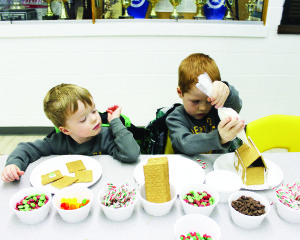 There were crafts for the younger folks to work on. Rowan Joyce, 3, and his brother Aiden, 5, of SouthFields Village were working on their gingerbread houses.