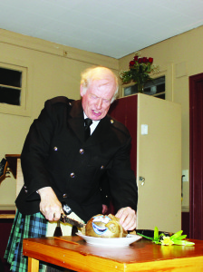 CELEBRATING ROBBIE BURNS IN PALGRAVE Joe Thompson of Orangeville delivered the Address to the Haggis last Friday night at the Robbie Burns Supper at the Orange Hall in Palgrave. It was the first time such an event has ever been put on by the Sandhill Pipes and Drums. Photo by Bill Rea