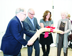 What better way to open the Exchange than by breaking bread, as opposed to cutting a ribbon? David and Marty Graham of Inglewood flanked CCS CEO Monty Laskin and Director of Community Resources Michelle Stubbs in breaking this loaf. Photo by Bill Rea