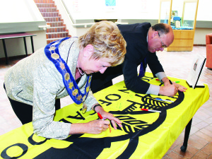 TOWN WISHED FLAXEY ‘GOOD CURLING' Mayor Marolyn Morrison and Councillor Allan Thompson were signing the Caledon flag Tuesday, conveying good wishes to local resident Caleb Flaxey, a member of Canada's curling team at the Sochi Olympics. “It is such an honour to recognize such high achievement in sport,” Morrison said. “I know all of our residents will join council and staff to support Caleb and to celebrate his commitment to his sport. We wish him an exciting, safe and memorable journey.” The public is encouraged to drop by and sign notes of encouragement to Flaxey. The Town flag will be available for signing until tomorrow (Friday) at Town Hall at 6311 Old Church Rd. in Caledon East.  Photo by Bill Rea