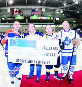 NHL alumni Paul Coffey and Darryl Sittler flanked Osler Foundation President and CEO Ken Mayhew and top fundraiser Tony Santos at centre ice for the cheque presentation following the match at the recent Hockey Night for Osler. Photo submitted