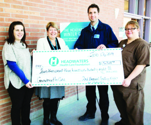 Headwaters Health Care Centre CEO Liz Ruegg gratefully accepts the proceeds from Hockey Night for Headwaters from committee members, Janet Gordanier, John Roberto and Patty Napran