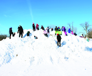 Lots of kids at SnowFest had a great time climbing this mountain of snow.