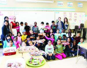 LOTS OF CUP CAKES Feb. 24 was National Cup Cake Day, and Grade 2 students at SouthFields Village Public School marked the occasion by baking cup cakes and selling them around the school. The day is marked by the Society for the Prevention of Cruelty to Animals and the Humane Society. Photo by Bill Rea